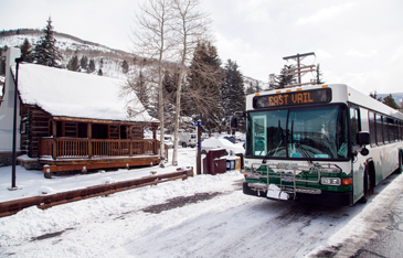 East Vail bus in a winter scene near a snowy bus stop